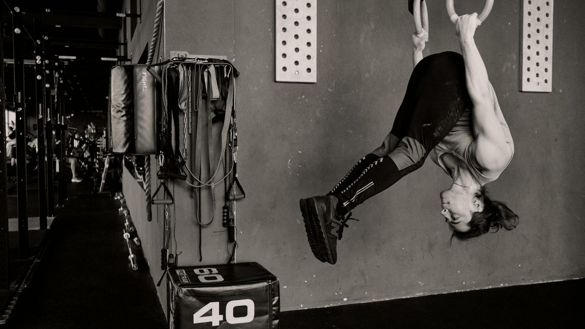 Athletic man performing strength exercises in a minimalist industrial gym environment
