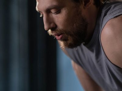 Man resting between sets looking focused and determined